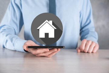 Real estate concept, businessman holding a house icon.House on Hand.Property insurance and security concept. Protecting gesture of man and symbol of house.flat icons with long shadows