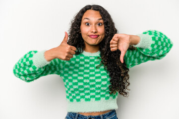 Young hispanic woman isolated on white background showing thumbs up and thumbs down, difficult...