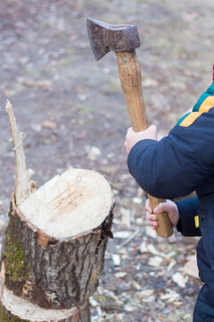 Child Chopping Wood With An Ax In Winter In Ukraine