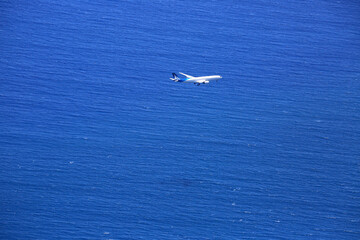Plane over the ocean before landing in Reunion island