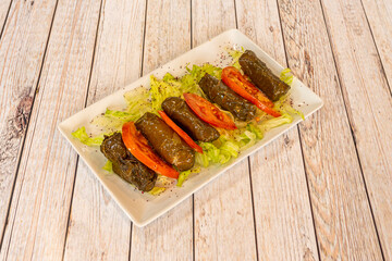Yaprak is the generic name for a food made from grape leaves, mainly from a variety of grapes called sultana grapes, stuffed with pork or lamb and rice, plus condiments.