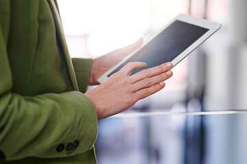 Tablets are great productivity tools. Cropped shot of a businesswoman holding a digital tablet.
