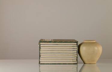 Chinese traditional books and white antique porcelain against white background