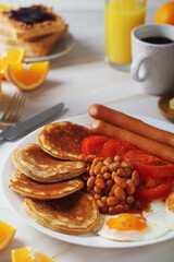 Traditional British breakfast with sausages and beans	