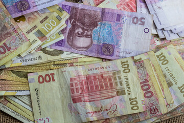 Paper money different denominations, Ukrainian hryvnia in denominations 50,100, 200 hryvnias, new money, background with scattered banknotes