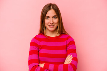 Obraz premium Young caucasian woman isolated on pink background who feels confident, crossing arms with determination.