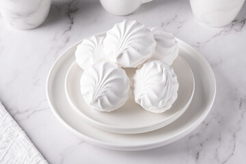 White marshmallows on a plate on a light table