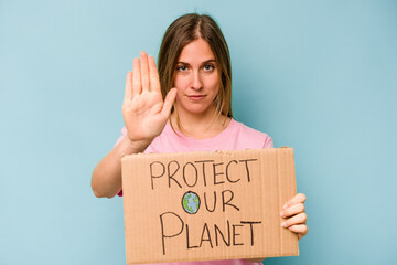 Fototapeta na wymiar Young caucasian woman holding protect your planet placard isolated on blue background