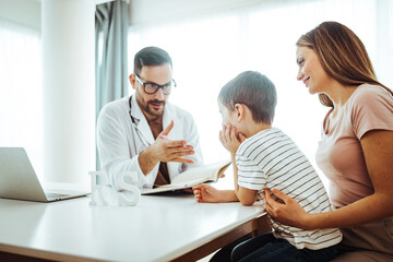 Male pediatrician hold stethoscope exam child boy patient visit doctor with mother,  paediatrician check heart lungs of kid do pediatric checkup in hospital children medical care concept