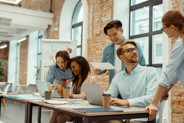 Creative business team using laptop in brainstorming at office