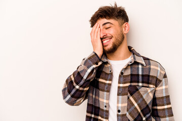 Fototapeta premium Young hispanic man isolated on white background laughing happy, carefree, natural emotion.