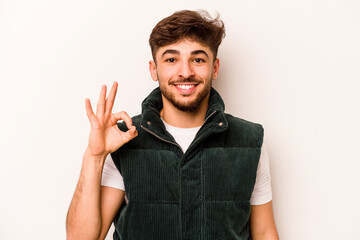 Young hispanic man isolated on white background cheerful and confident showing ok gesture.