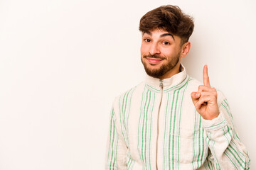 Fototapeta premium Young hispanic man isolated on white background showing number one with finger.