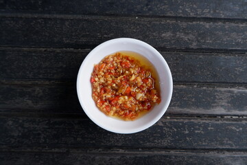 Sambal korek or Indonesian chili sauce or paste is usually made from a mixture of various chilies with additional ingredients such as shrimp paste, garlic, ginger, shallots and stir-fry - obrazy, fototapety, plakaty