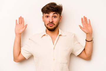 Fototapeta premium Young hispanic man isolated on white background being shocked due to an imminent danger
