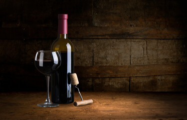 red wine bottle and wine glass on wodden barrel