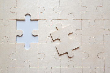 jigsaw puzzle pieces
Top view of wooden white puzzle.
