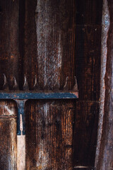 Metal garden rake on natural weathered wood background with copyspace