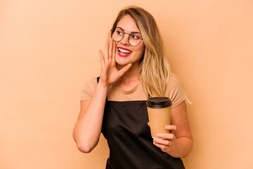 Restaurant waiter caucasian woman holding a take away coffee isolated on beige background shouting and holding palm near opened mouth.