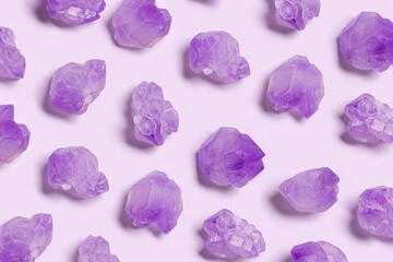 Creative pattern of purple amethyst crystals on very peri color background,  top view natural...