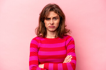 Young caucasian woman isolated on pink background unhappy looking in camera with sarcastic expression.