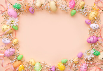 Easter background with eggs and flowers. Top view on a flat orange background. Greeting card template with a space to copy.