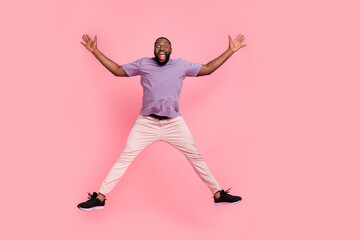 Fototapeta na wymiar Full length body size view of attractive cheerful guy jumping fooling isolated over pink pastel color background
