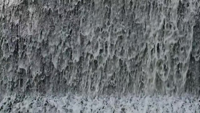 Artificial shaded waterfall on dam on Hirskyi Tikych river, Buky Canyon, Cherkasy Region, Ukraine.
