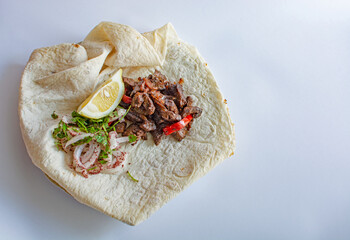 Turkish liver kebab (Ciger Kebab) on the dinner plate.