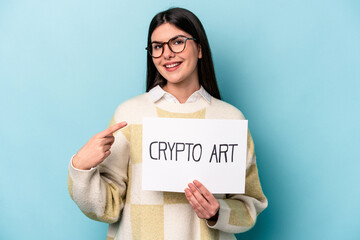 Fototapeta na wymiar Young caucasian business woman holding a crypto art placard isolated on blue background smiling and pointing aside, showing something at blank space.