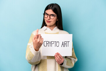 Young caucasian business woman holding a crypto art placard isolated on blue background pointing with finger at you as if inviting come closer.