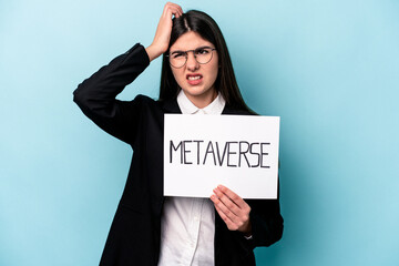 Young caucasian business woman holding a metaverse placard isolated on blue background being...
