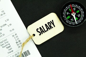 compasses, receipts and wooden tags with the word salary