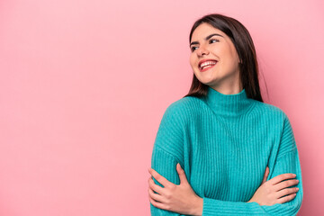 Fototapeta premium Young caucasian woman isolated on pink background smiling confident with crossed arms.