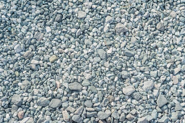 A pattern of gray gravel. The road surface is made of crushed stone