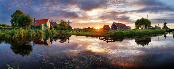 Panorama landscape of dutch windmills near canal at sunset. Netherlands. - obrazy, fototapety, plakaty