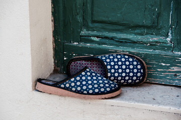 Old home slippers at the entrance of a house in Lisbon