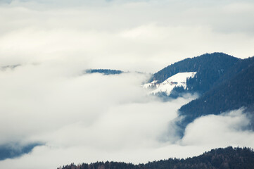 Fog in winter mountains at sunrise. Dolomite Alps, Italy