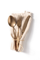 Cutlery. A spoon, a fork, and a knife in a blue napkin on a white background. Modern tableware,...