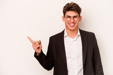Young caucasian business man isolated on white background smiling and pointing aside, showing something at blank space.