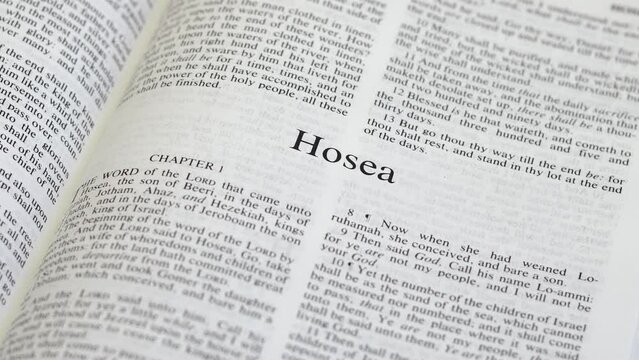 Close Up Shot of  Bible Page Turning to the book of Hosea
