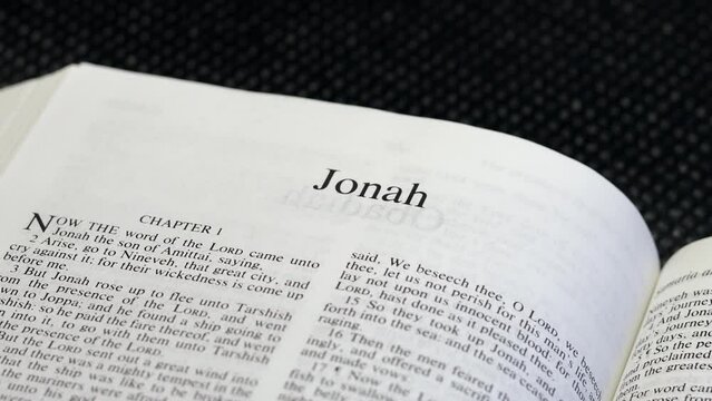 Close Up Shot of  Bible Page Turning to the book of Jonah