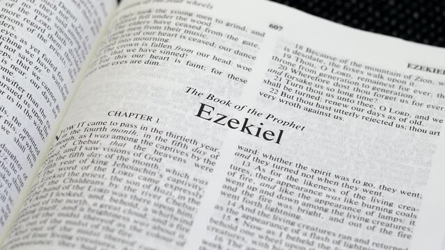 Close Up Shot of  Bible Page Turning to the book of Ezekiel