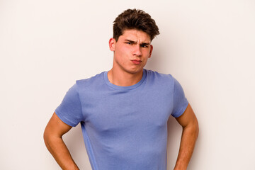 Obraz premium Young caucasian man isolated on white background confused, feels doubtful and unsure.