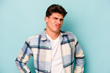 Fototapeta premium Young caucasian man isolated on blue background sad, serious face, feeling miserable and displeased.