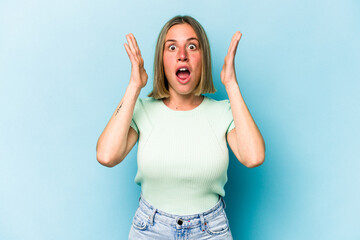 Young caucasian woman isolated on blue background surprised and shocked.