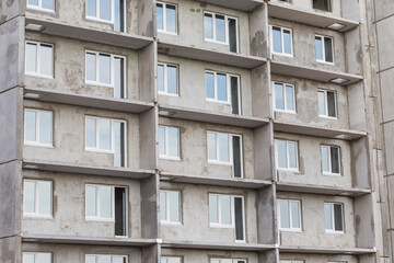 Facade of a modern building under construction. Multi-storey residential building under construction. Panel house. Construction concept. Close view.
