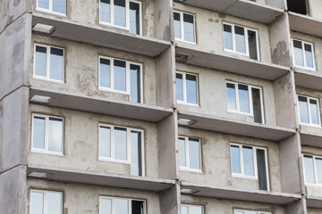 Facade of a modern building under construction. Multi-storey residential building under construction. Panel house. Construction concept. Close view.