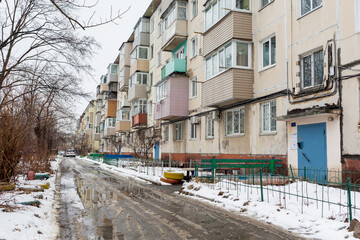 View of Khrushchyovka, common type of old low-cost apartment building in Russia and post-Soviet space. Kind of prefabricated buildings. Built in 1960s. Winter shot. Russia, Vladivostok. - obrazy, fototapety, plakaty