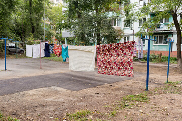 Laundry dries on the rope in courtyard of Khrushchyovka. Khrushchyovka is common type of old low-cost apartment building in Russia and post-Soviet space. Household concept. Russia, Vladivostok.